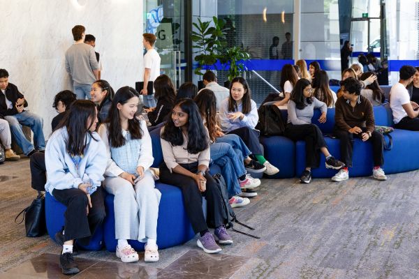 Many students gathered, sitting in foyer