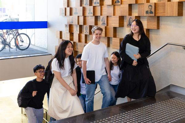 A group of students walking up the stairs in the Spot building