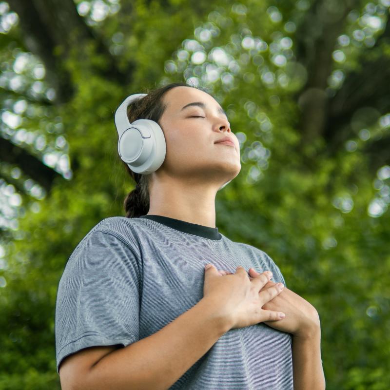 Person with headphones on breathing deeply 