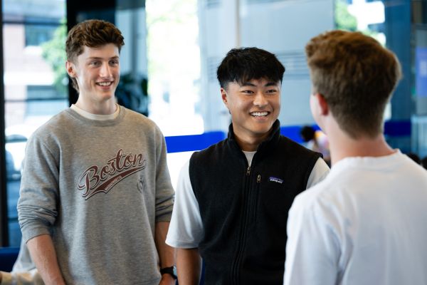 3 students casually talking to each other 